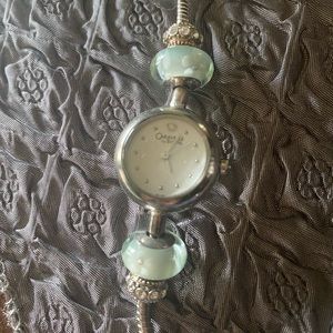 NWOT Caravelle by Bulova Charm Watch -adjustable bracelet. Glass & crystal beads